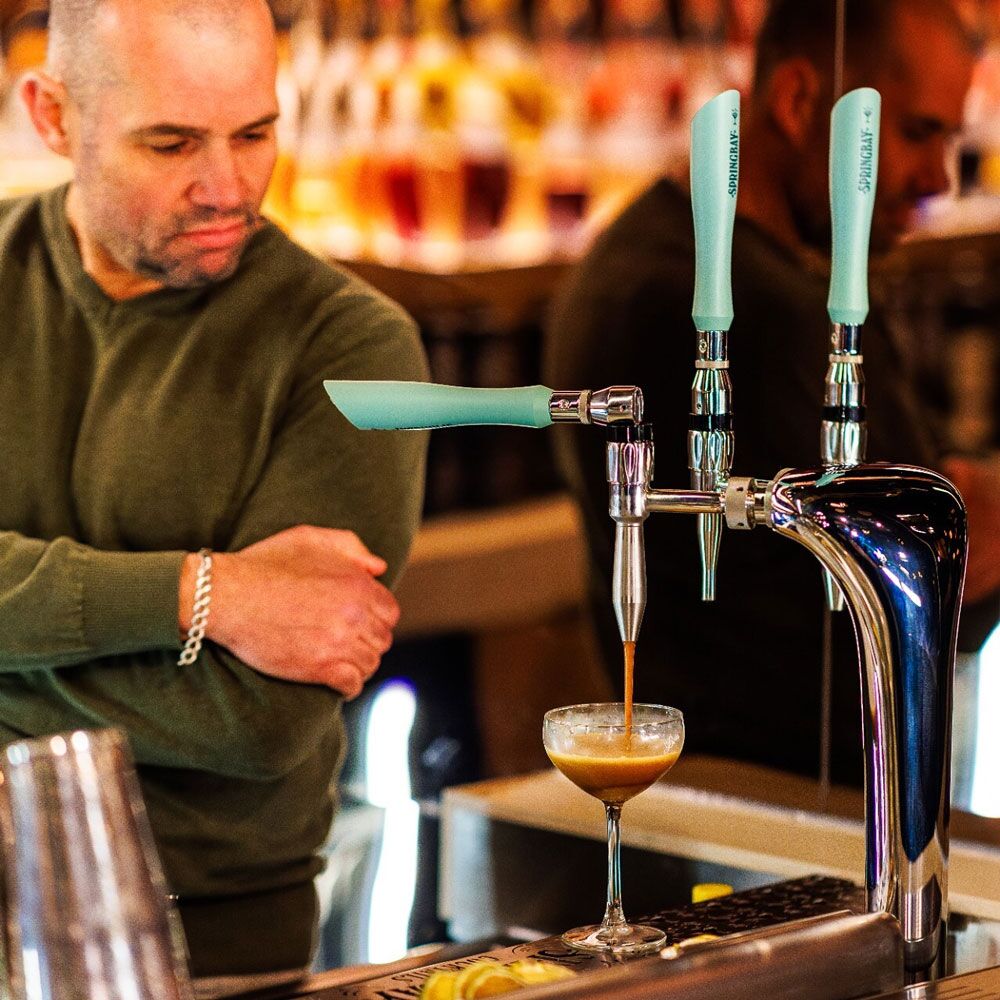 Bartender pours an espresso martini from the Springbay 3-tap during the Bols collaboration