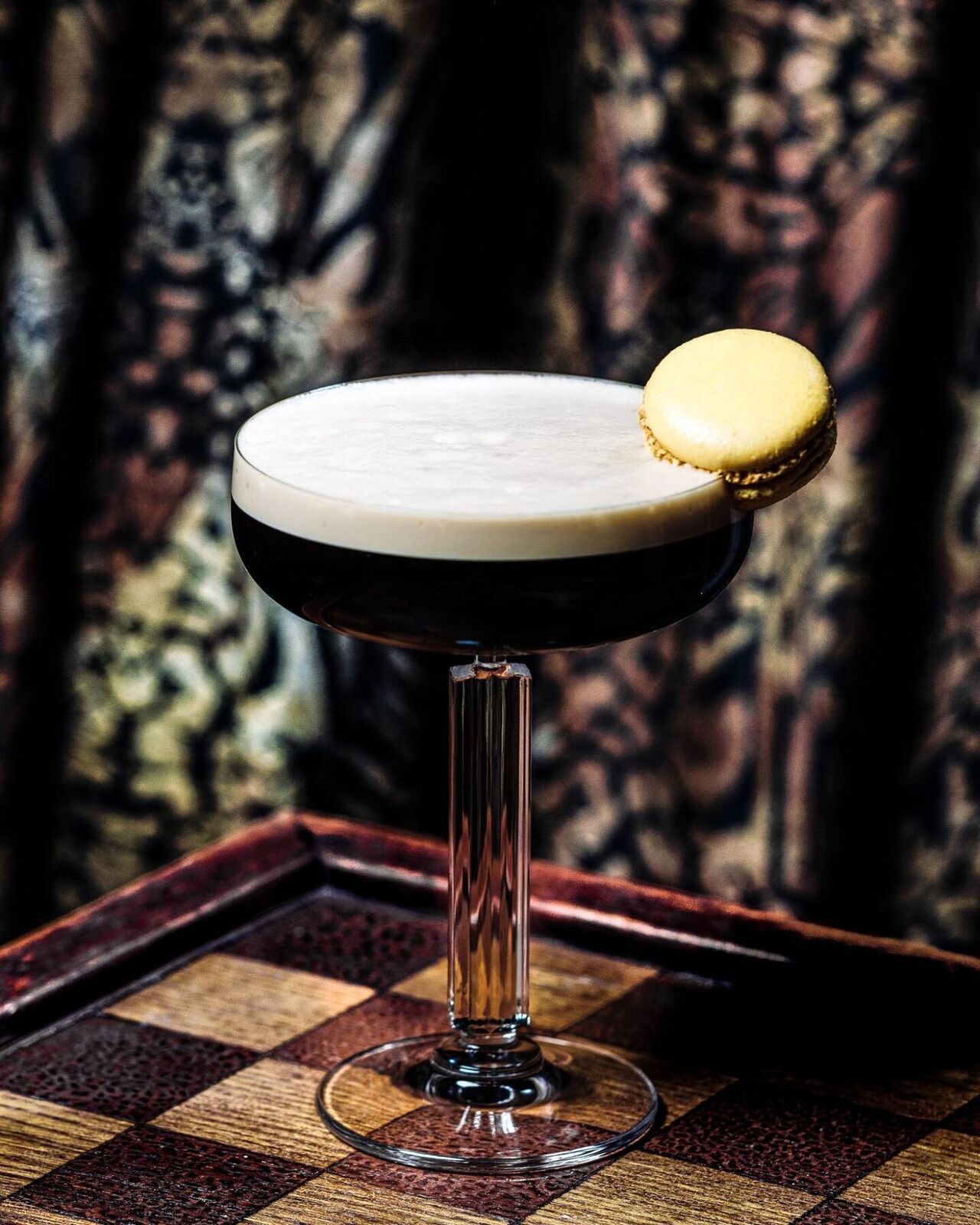 Tapped espresso martini in a coupe with a biscuit on the rim