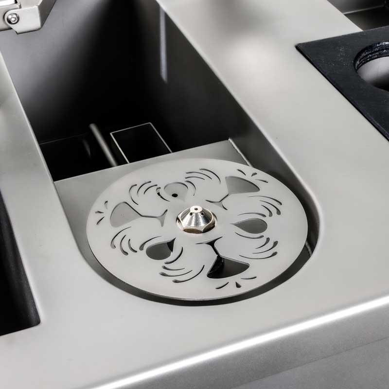 Close-up of the engraved glass rinser set into the stainless steel work surface