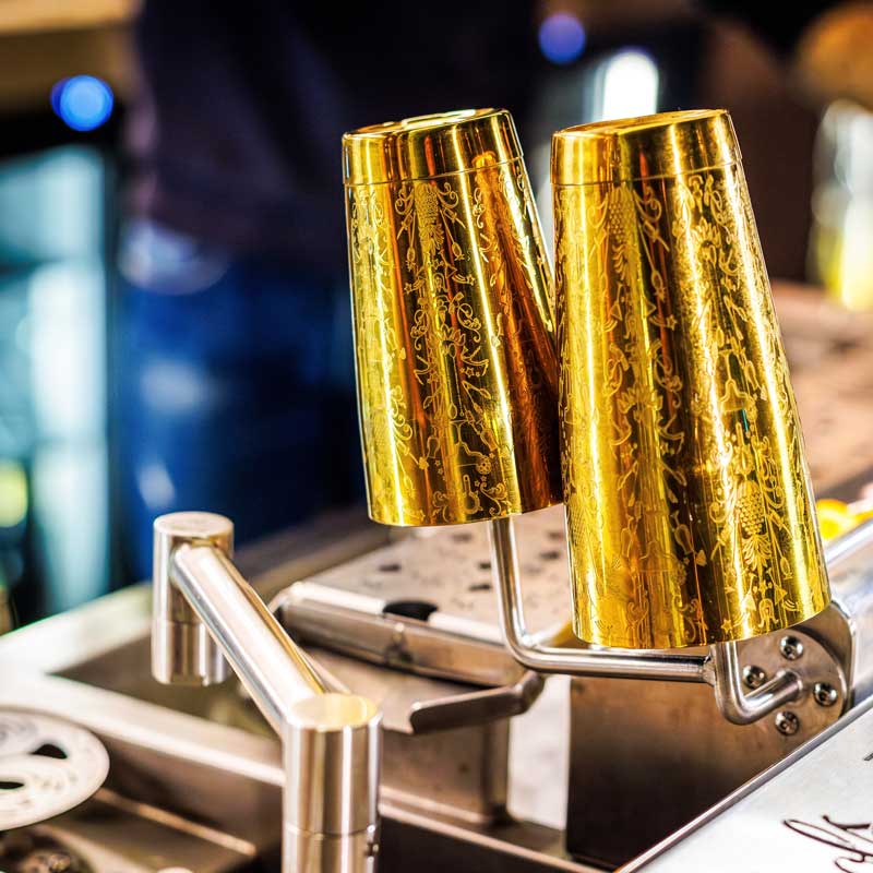 Gold cocktail glasses on the glass rack above the Springbay station