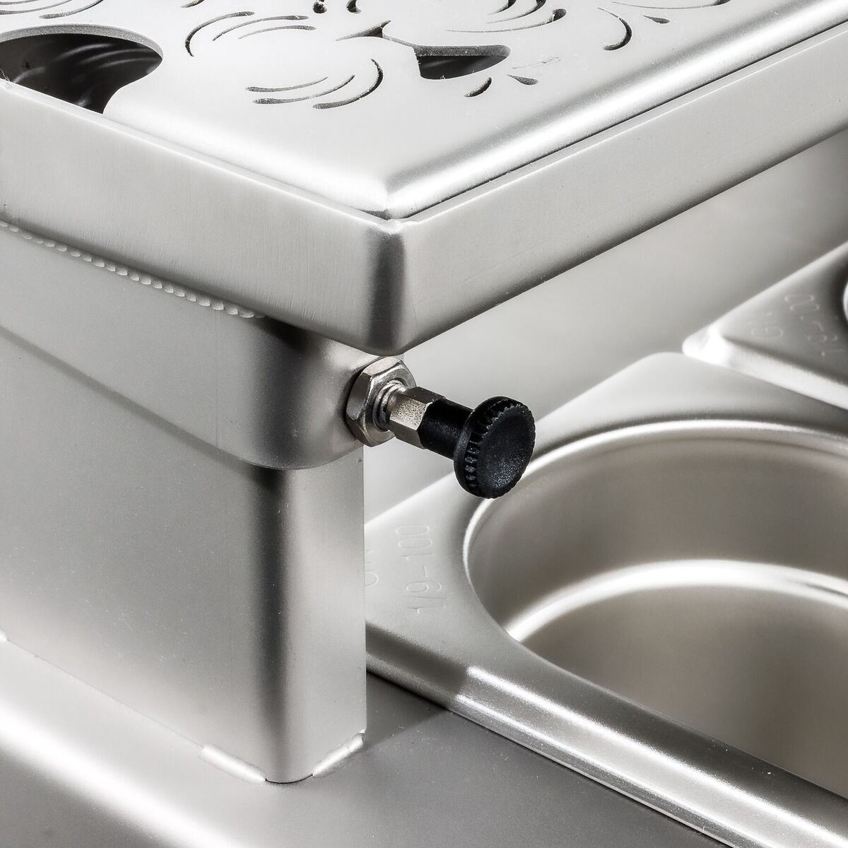 Detail of the engraved lid and closing knob of the garnish tray